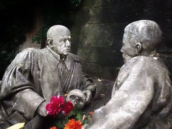 Statue of people in cemetery