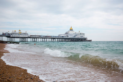 Eastbourne beach and pier, east sussex, england. a summertime view across the shoreline.