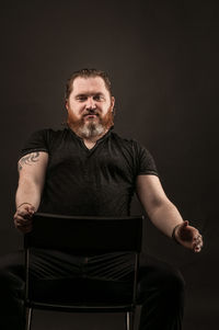 Portrait of man sitting on chair