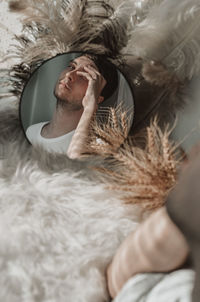 High angle view of man sleeping on bed