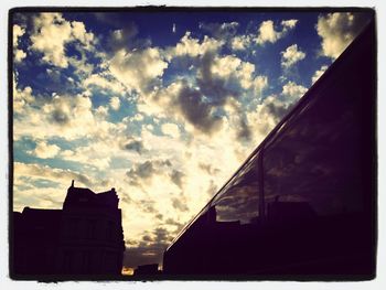 Low angle view of building against cloudy sky