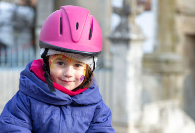 Portrait of smiling girl wearing cycling helmet