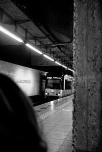 Train at railroad station platform at night