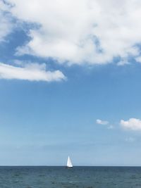 Boat sailing in sea against sky