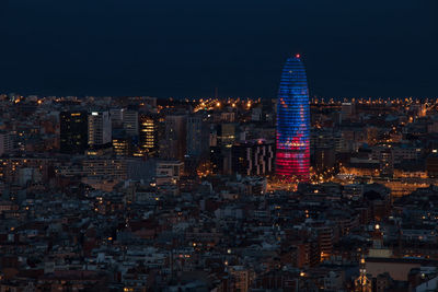 Illuminated cityscape against sky at night