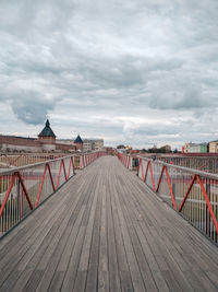 Footbridge over water against sky