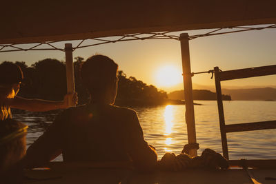 Rear view of people looking at sunset