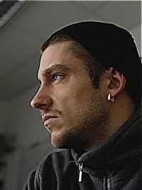 Close-up portrait of a serious young man looking away