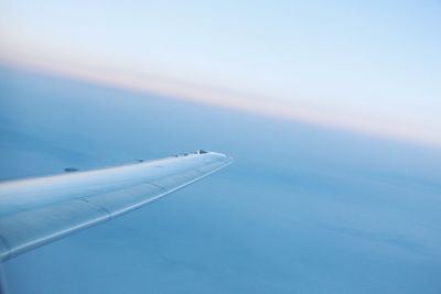 Aerial view of airplane wing in sky