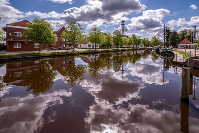 Reflection of trees and buildings in lake