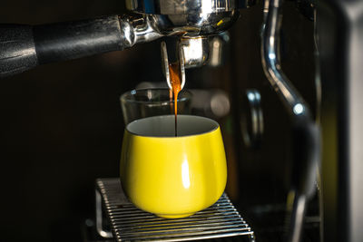 Close-up of coffee pouring in glass