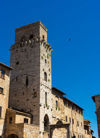 Low angle view of historic building against blue sky