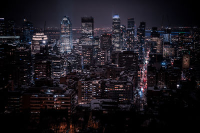 High angle view of illuminated buildings in city at night