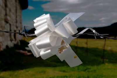 Close-up of white umbrella against sky