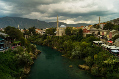 Panoramic view of buildings and trees against sky in city