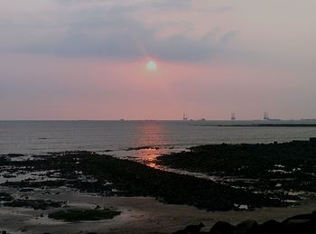 Scenic view of sea at sunset