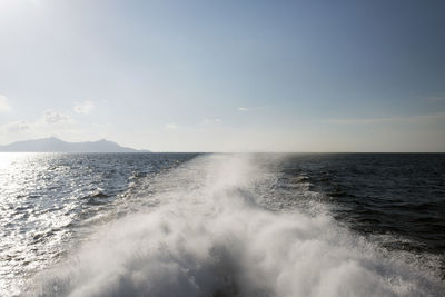 A view of a horizon, seascape, waves and splash caused by catamaran in the aegean sea in summer time