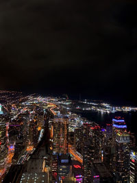 High angle view of illuminated city buildings at night