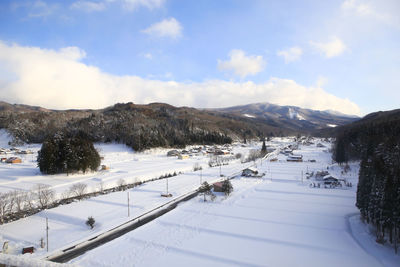 Scenic view of snow covered mountains against sky