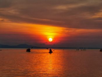 Scenic view of sea against orange sky