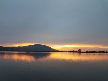 Scenic view of lake against sky during sunset