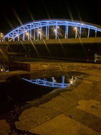 Illuminated bridge at night