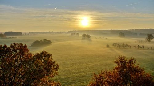 Scenic view of landscape against sky during sunset