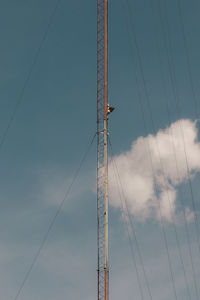 Low angle view of electricity pylon against sky