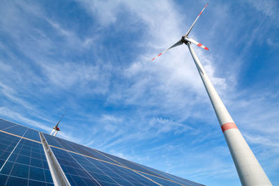 Low angle view of windmill against blue sky