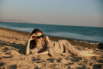 Portrait of woman sitting at beach