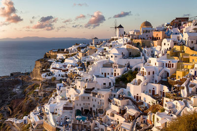 High angle view of townscape by sea against sky