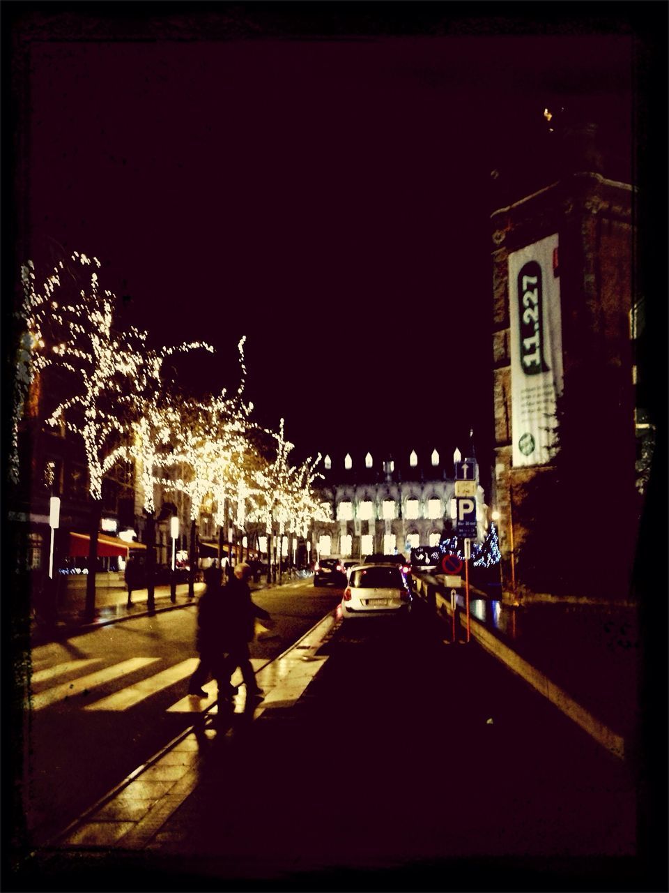 night, illuminated, building exterior, street, men, lifestyles, architecture, city, walking, built structure, street light, city life, leisure activity, person, road, transportation, city street, full length, clear sky