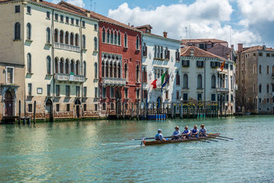 Boats in river with buildings in background