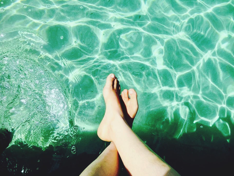 LOW SECTION OF WOMAN SWIMMING IN POOL