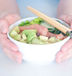 Midsection of person holding salad