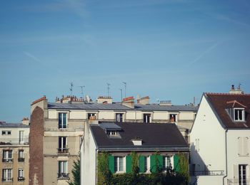Buildings in city against sky
