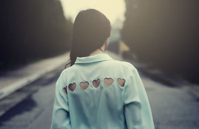 Rear view of friends standing on street