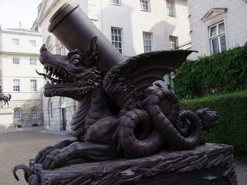 Close-up of statue against building in city