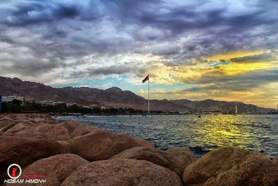 Scenic view of mountains against cloudy sky