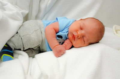 Cute baby sleeping on bed at home