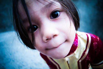 Close-up portrait of boy biting lip