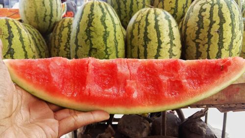 Close-up of hand holding a watermelon 