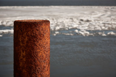 Close-up of wooden post on snow