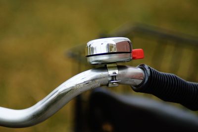Close-up of hand holding bicycle