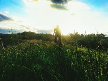 Man standing on field against sky