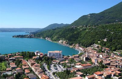 High angle view of townscape by lake garda against clear sky