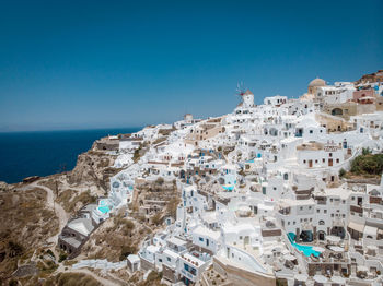 Panoramic view of buildings and sea against clear blue sky