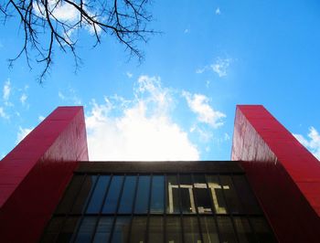 Low angle view of modern building against blue sky