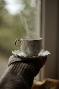 Cropped hand holding coffee