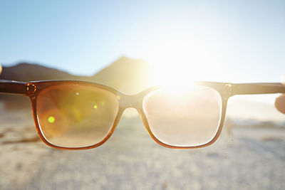 Close-up of sunglasses on rock